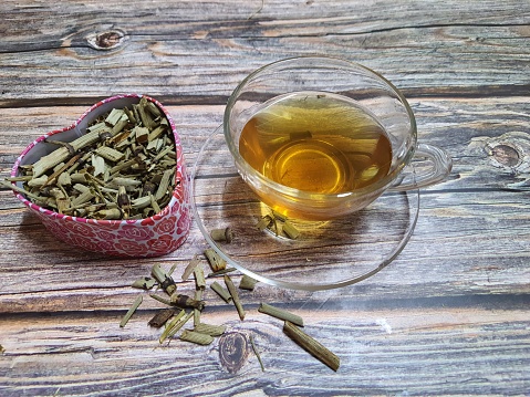 A cup of horsetail tea with dried equisetum plant. Organic herb used in alternative medicine.