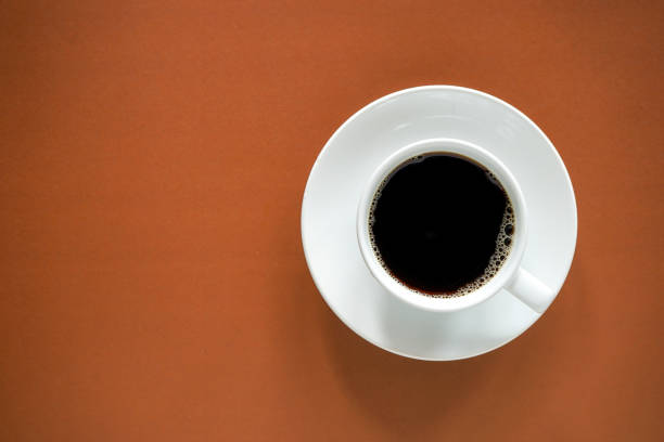 istock Cup of black coffee on brown background with copy space 1405773614