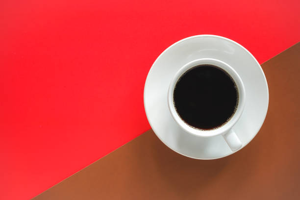 istock Cup of black coffee on abstract red and brown background 1405773627