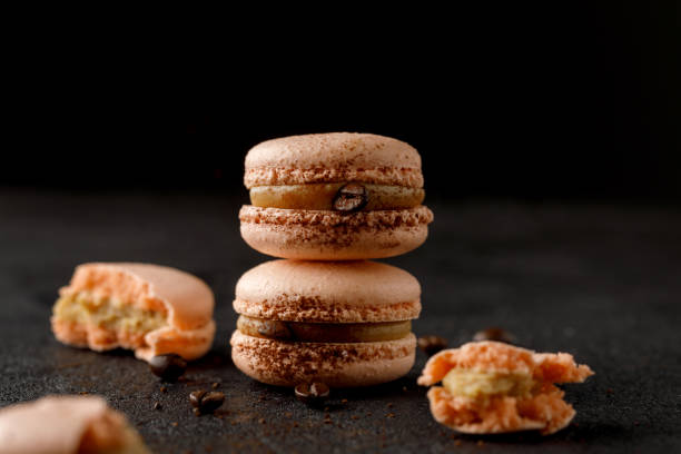 istock Macarons with biscuit flakes and black background. 1405775517