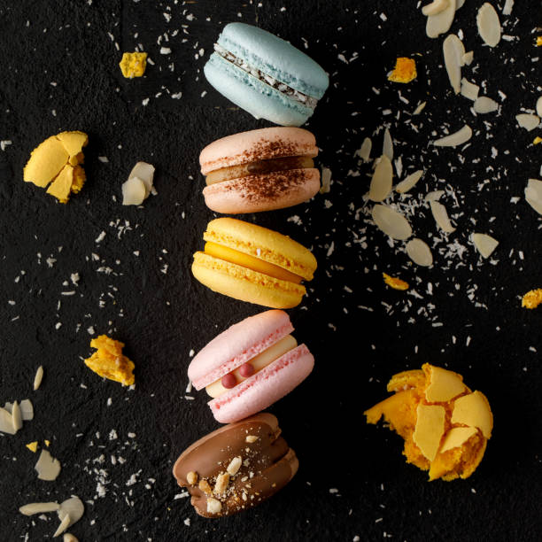 istock Macarons with biscuit flakes and black background. 1405775519