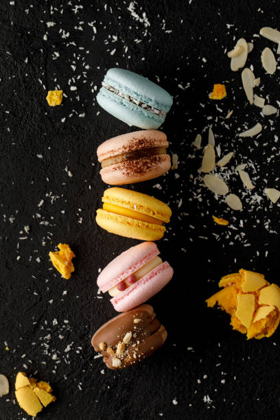 istock Macarons with biscuit flakes and black background. 1405775546