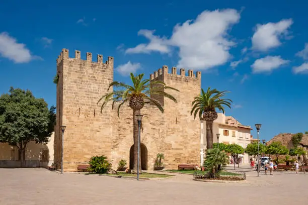 Wide angle view of Porta del Moll, sporting two towers, this solitary 14th-century gate is one of the two surviving gates of Alcudia, Majorca, Spain.