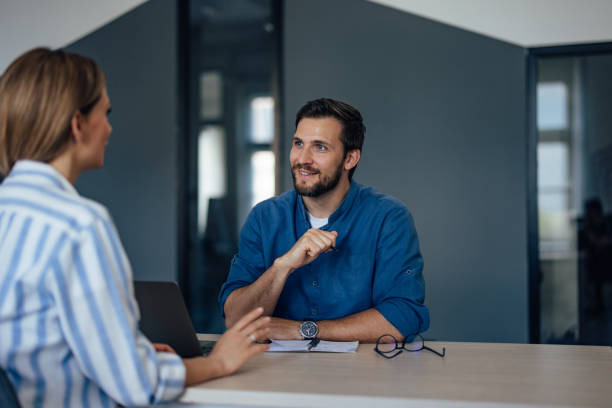 istock A focused man talking to a female client has a business conversation. 1405776495