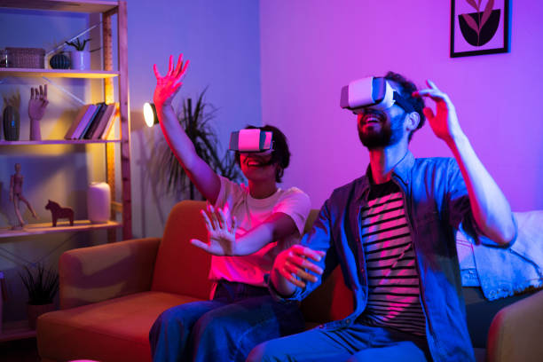Young couple playing VR games and having fun at home