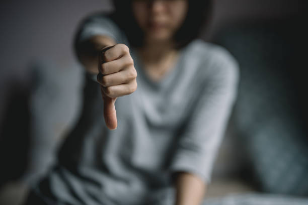 istock Frustrated woman showing thumbs down gesture. 1405776842