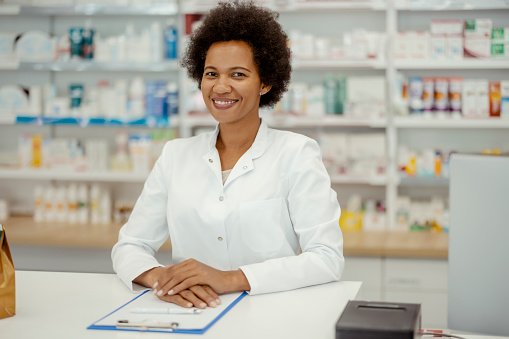 Pharmacy: Portrait of African American Female Pharmacist Looks at Camera