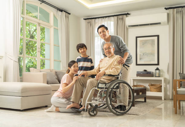 Portrait of happy smiling Asian Family living together at home in family relationship. reunion. Love of father, mother,grandfather and son. People lifestyle. stock photo