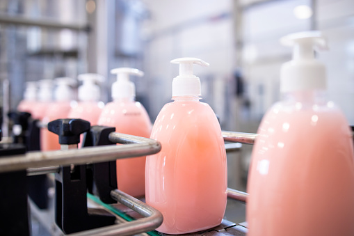 Bottled liquid soap being produced in factory.