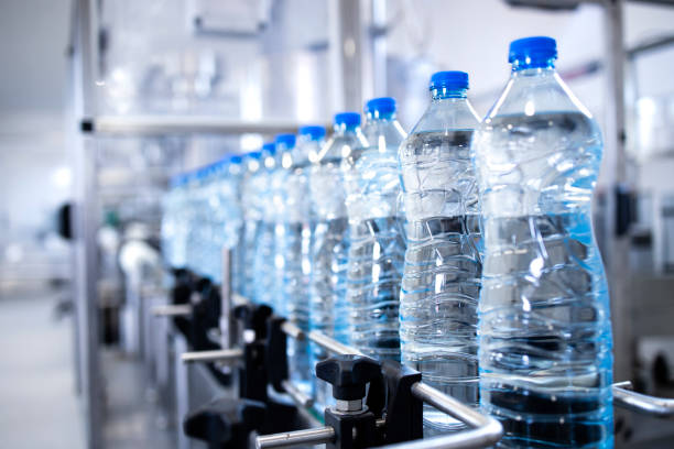 istock Plastic bottles on conveyor belt being filled with drinking water. 1405779841