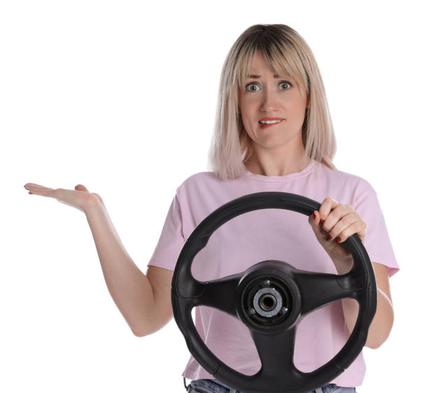 istock Emotional woman with steering wheel on white background 1405781093