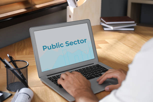 istock Public Sector. Man working with modern laptop at wooden table, closeup 1405781379