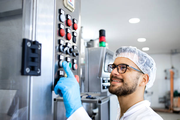 istock Working in pharmaceutical factory technologist operating production machine. 1405781513