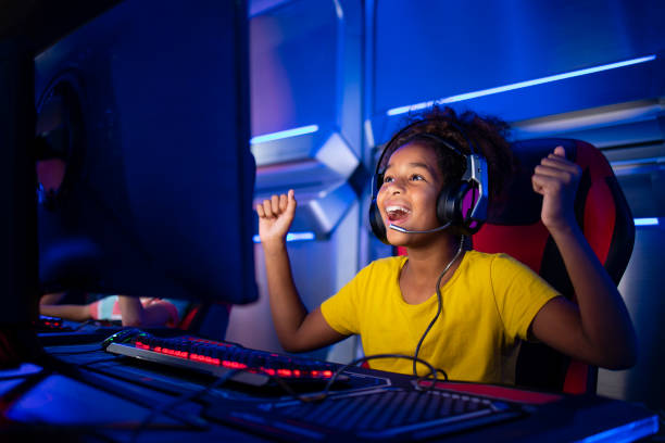 Cute young girl feeling happy and excited for winning computer video game. Cute young girl feeling happy and excited for winning computer video game. surfing the net stock pictures, royalty-free photos & images