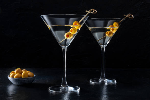 Martini, two glasses with spicy olives, on a dark background stock photo