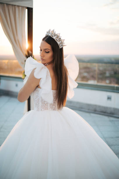 istock Beautiful bride posing in white princess dress with crown. 1405787253
