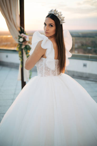 istock Beautiful bride posing in white princess dress with crown. 1405787316