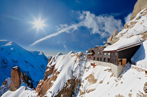 Snow covered mountain hut old farmhouse in the ski region of Saalbach Hinterglemm in the Austrian alps at sunrise against blue sky