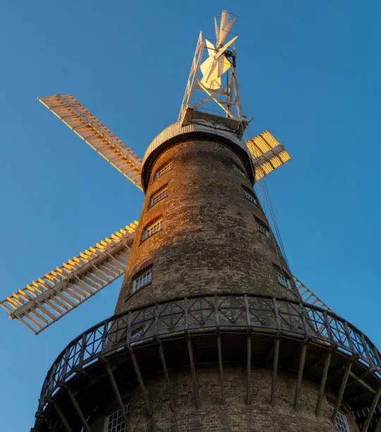 Moulton Windmill, near Spalding in Lincolnshire in low summer sun at golden hour under a clear blue sky