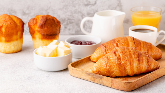 Hot coffee, croissants on a light background, selective focus. Breakfast concept