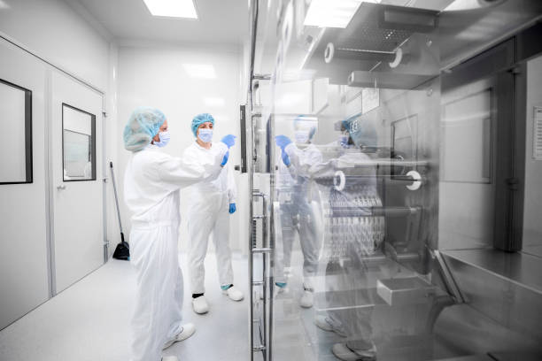 Drug manufacturing - pharmaceutical industry and its female scientists employees stock photo
