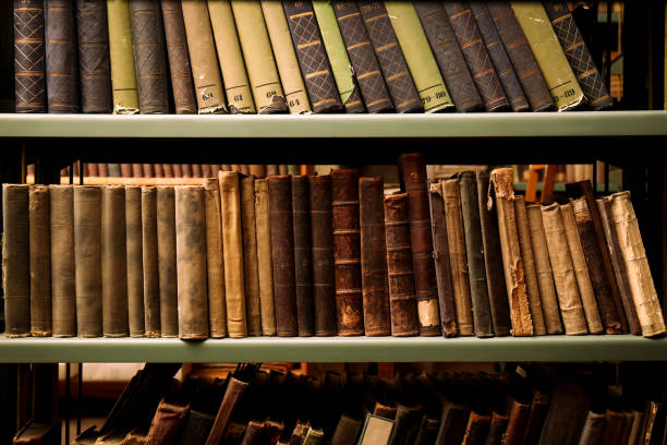 istock Collection of old books on shelves in library 1405790565