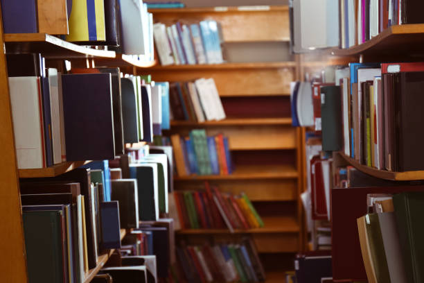 istock Collection of different books on shelves in library 1405790569