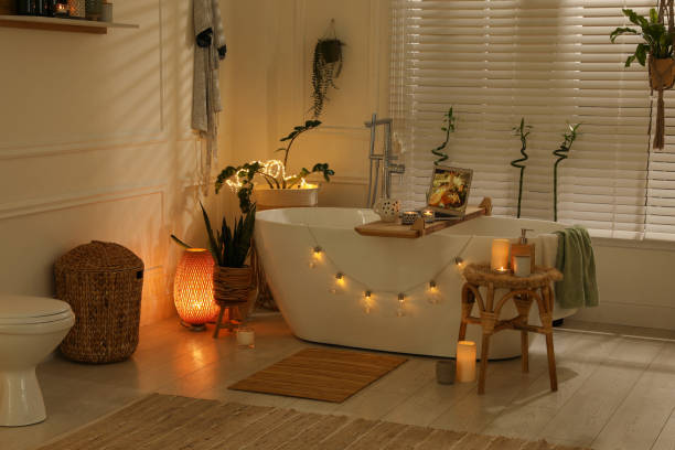 Stylish bathroom interior with green houseplants and string lights. Idea for design