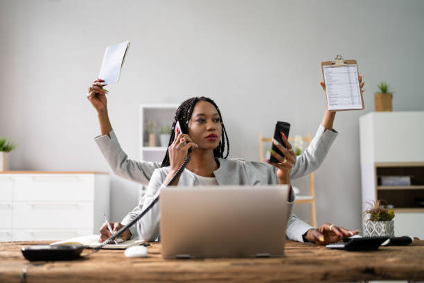 Multitasking Businesswoman In Office Smiling Young Businesswoman Doing Multitasking Work At Workplace multi tasking stock pictures, royalty-free photos & images