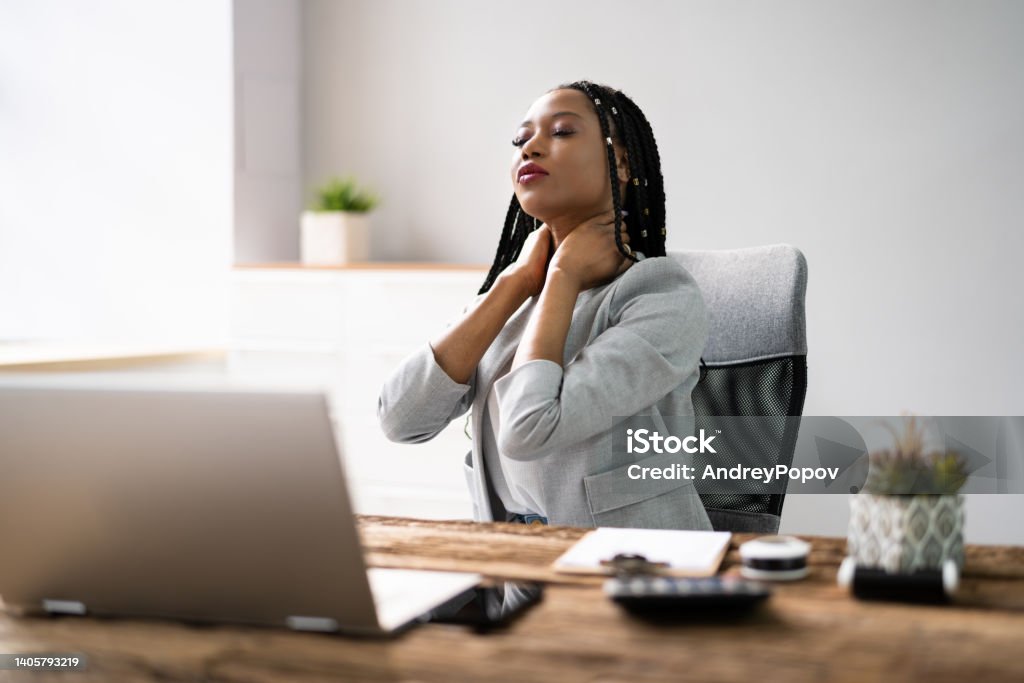 Woman With Bad Posture And Ergonomics Woman With Bad Posture And Ergonomics While Sitting Data Stock Photo