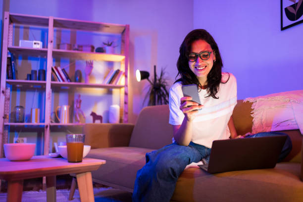 Portrait of a young woman freelancing and using smartphone stock photo