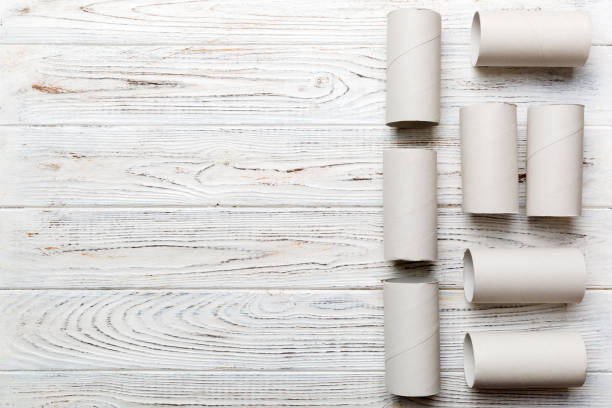 istock Flat lay composition with empty toilet paper rolls and space for text on color background. Recyclable paper tube with metal plug end made of kraft paper or cardboard 1405793551