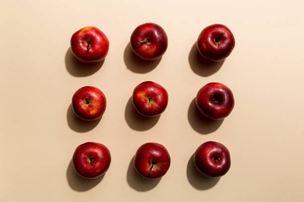 istock Many red apples on colored background, top view. Autumn pattern with fresh apple above view 1405793575