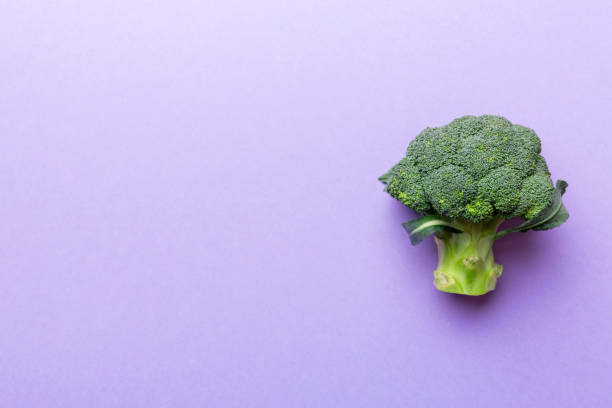 istock Top view fresh green broccoli vegetable on Colored background. Broccoli cabbage head Healthy or vegetarian food concept. Flat lay. Copy space 1405793631