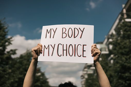 Woman holding a sign \