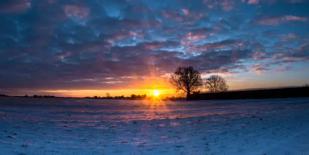 Spectacular Winter sunrise over flat agricultural land in the Fens in the East of England, Spalding, Lincolnshire.