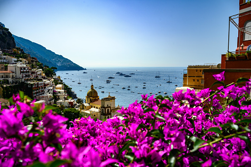 View over the Mediterranean Sea in Italy with bougainvillea flowers