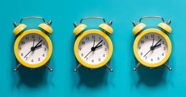 istock Yellow alarm clocks on blue background isolated, flat lay. 1405804521