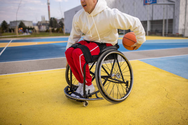 istock Disabled man in wheelchair practice basketball 1405805532