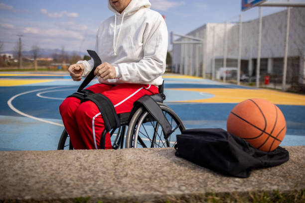 istock Disabled man unstraping his lower body in wheelchair 1405806635