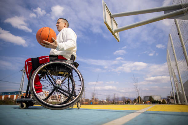 istock Disabled man in wheelchair practise basketball 1405806638