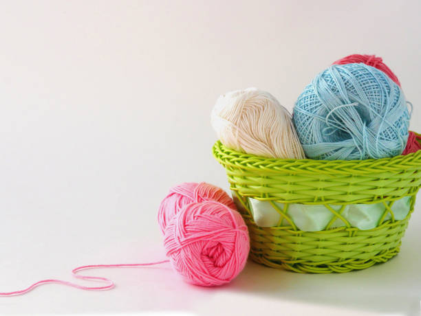 istock Yarn for knitting, colored balls in a green basket place for text 1405806797