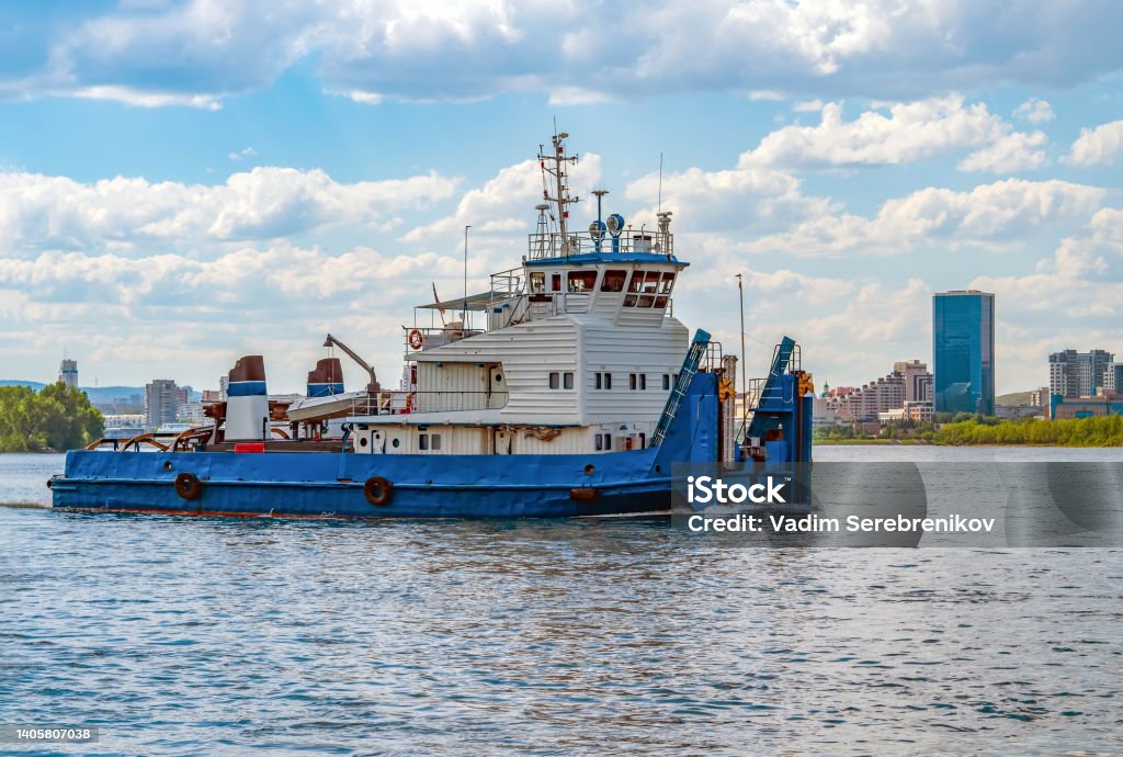 River tug boat is moving along the water Barge Stock Photo