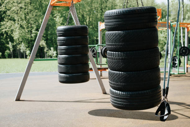 Sports ground in park outdoors. Rubber car tires for street training boxing, workout stock photo