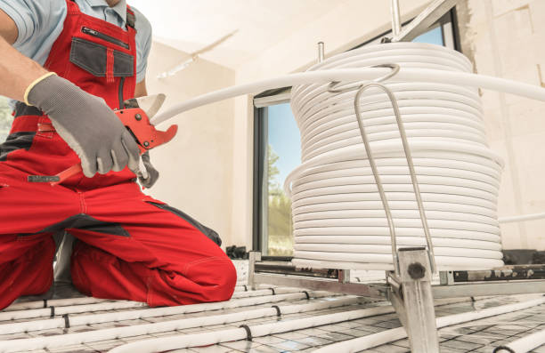 istock HVAC Worker Cutting Radiant Floor Heating Pipeline Using Tube Slicer 1405808597