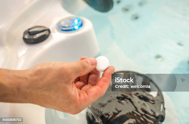 Using Chlorine Tabs In A Hot Tub Spa Stock Photo - Download Image Now - Hot Tub, Chemical, Repairing