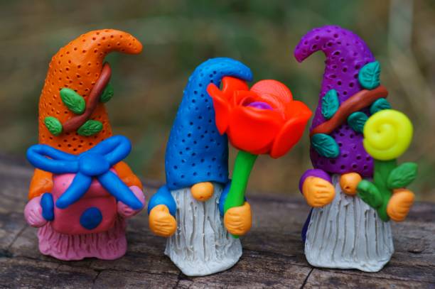 istock Toy gnomes with a flower and a gift. 1405810663
