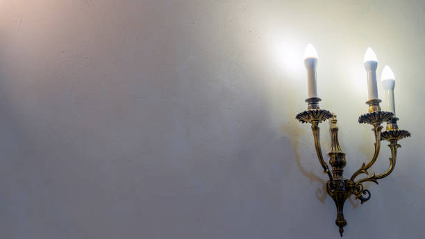 istock Vintage wall lamp. Space for text. Lamp light on the wall. Working lamps at dusk. 1405812053