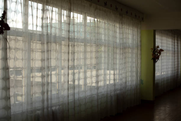 istock Curtains on large window in school. Curtains in corridor on window openings. 1405813569