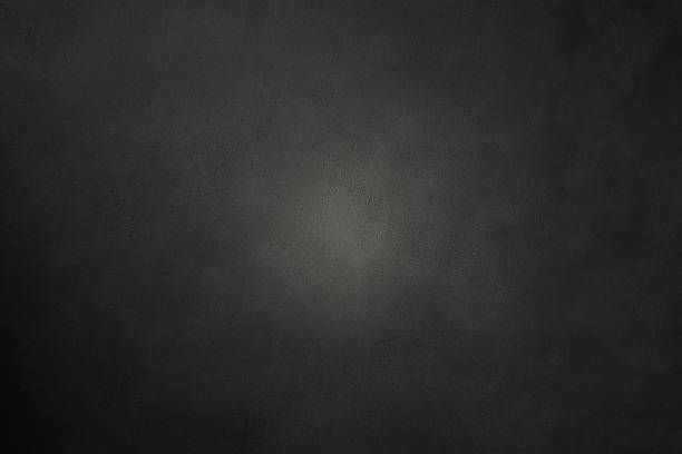 Dark photography backdrop. Concrete wall texture with lighting effect background.
